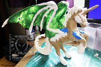 knightmare 00  Project: "I dont' know what I'm doing. 2" Materials: Decopatch extra small 'unicorn' blank figure, strong wire, glue gun, Kneadatite, Paperclay, Silk Clay. Project link:  "The Daemonslayers"  Character:  knightmare   More detail with the Paperclay - here I've started to add some definition to the blank's featureless, somewhat misshapen head.  Something that really bugs me is the horn - it's too chunky but under the paper is a plastic core and I was reluctant to try and whittle it down with a knife when the idea finally occurred to me that I could as the wings and tail were already on and I didn't want to risk breaking them if I got a bit cackhanded about it. The blue stuff forming his armour plating is silk clay.  It's really aimed at children but is easy and convenient to use, takes paint ok and in future I think I'll use it for horns and spikes and stuff because it's slightly supple when dried so less likely to snap off.  I couldn't find much online about the stuff on how it is long term, but I'm not exactly making gallery masterpieces here, am I?